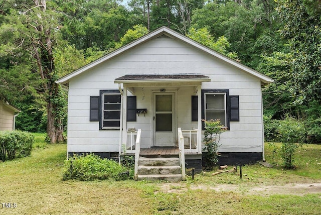 bungalow-style home with a front yard