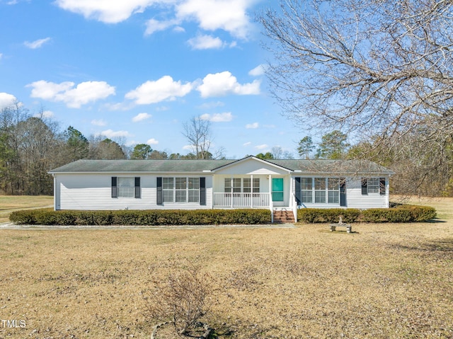 ranch-style house with a porch and a front lawn