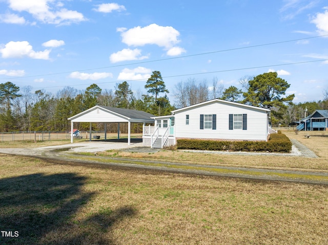 view of front facade with a carport and a front yard