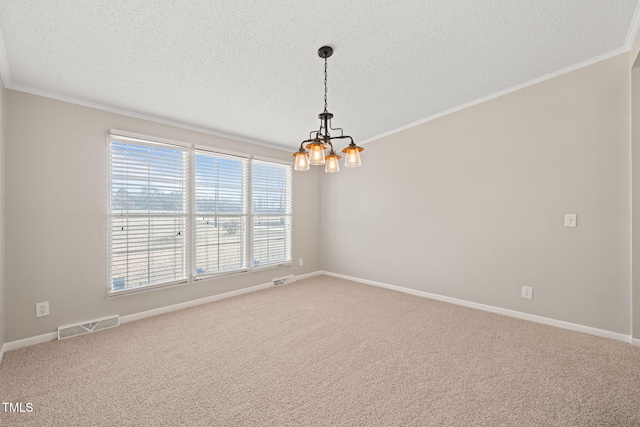 carpeted spare room with ornamental molding, a notable chandelier, and a textured ceiling