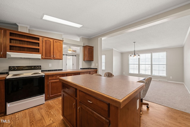 kitchen featuring light hardwood / wood-style flooring, hanging light fixtures, range with electric stovetop, ornamental molding, and a kitchen island