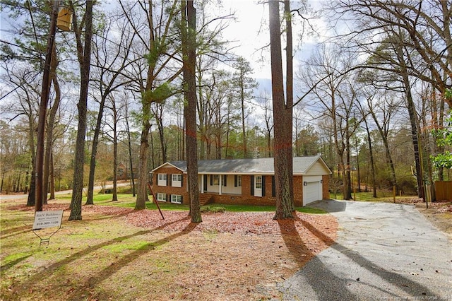 single story home featuring a garage and a front lawn