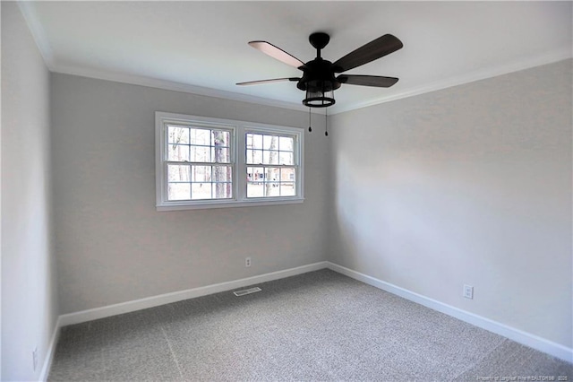 carpeted empty room with crown molding, ceiling fan, and baseboards