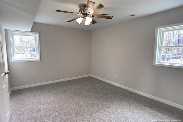 spare room with carpet floors, ceiling fan, and baseboards