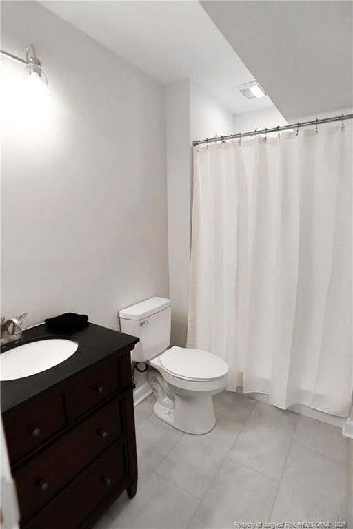 full bathroom featuring toilet, tile patterned flooring, vanity, and a shower with shower curtain