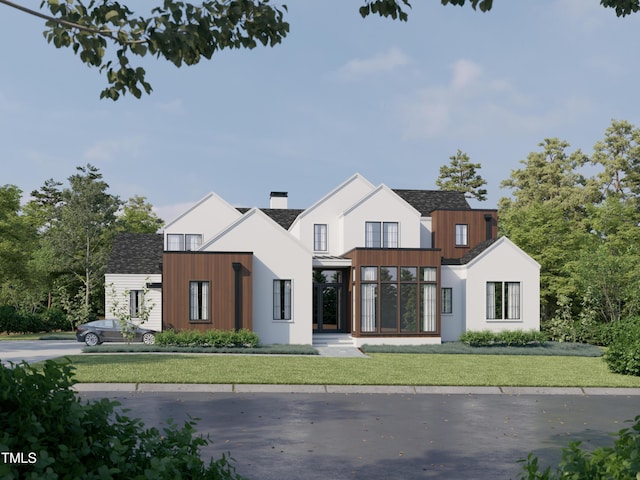 modern inspired farmhouse with a front yard, a standing seam roof, metal roof, and a chimney