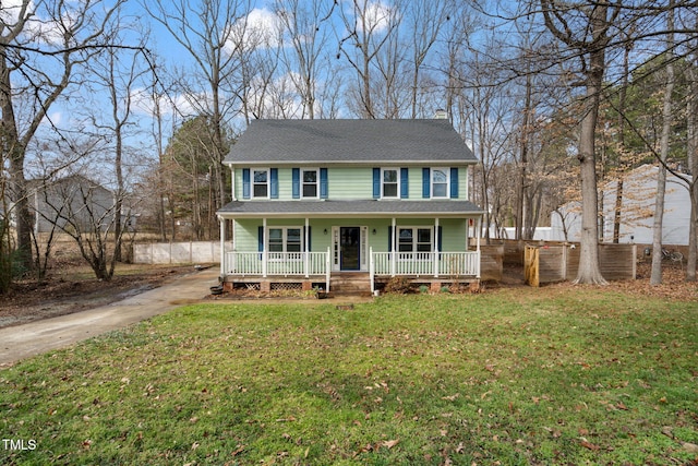 colonial inspired home with a front yard and covered porch