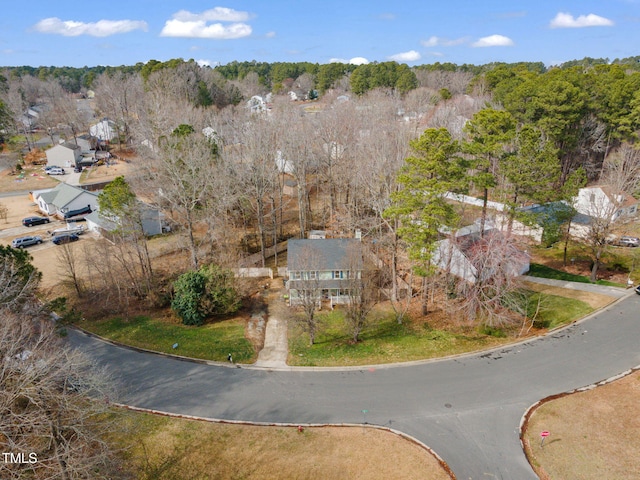 drone / aerial view with a wooded view