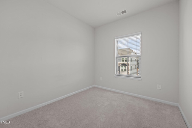 unfurnished room with baseboards, carpet flooring, and visible vents