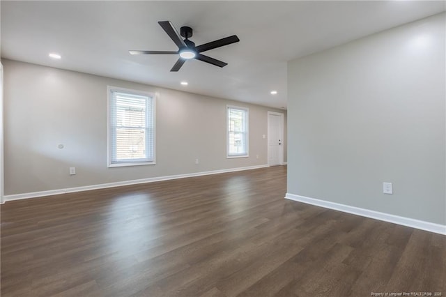 unfurnished room with dark wood-type flooring and ceiling fan