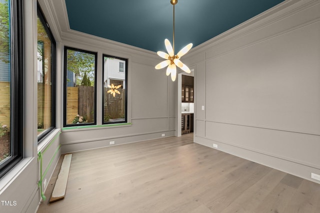 2305 Turners Aly, Raleigh, NC 27607 - unfurnished dining area with healthy amount of natural light, a decorative wall, crown molding, and wood finished floors