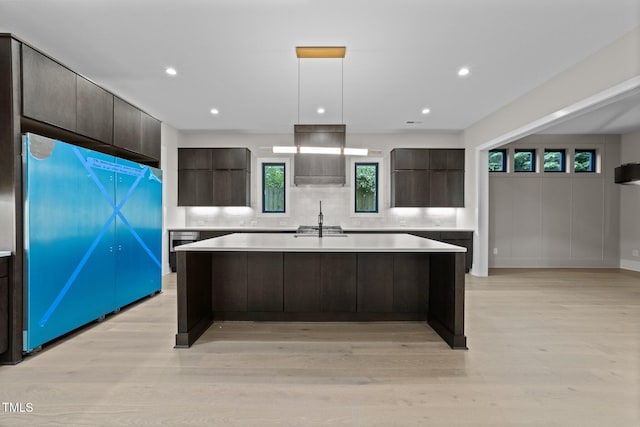 2305 Turners Aly, Raleigh, NC 27607 - kitchen featuring modern cabinets, freestanding refrigerator, light countertops, a kitchen island, and dark brown cabinetry