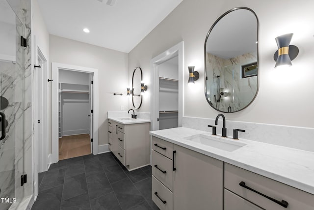 2305 Turners Aly, Raleigh, NC 27607 - full bath with a marble finish shower, a spacious closet, two vanities, tile patterned flooring, and recessed lighting