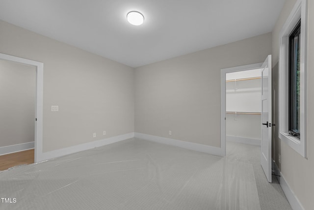 2305 Turners Aly, Raleigh, NC 27607 - unfurnished bedroom with a spacious closet, a closet, and light colored carpet
