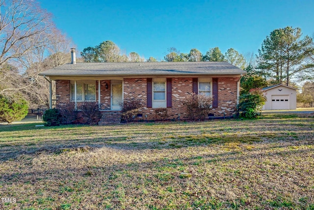 ranch-style home with a front yard, a garage, a porch, and an outbuilding