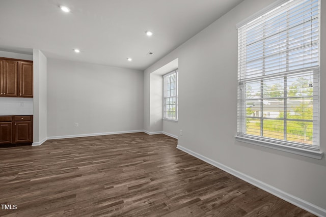 1414 Excelsior Grand Ave, Durham, NC 27713 - unfurnished living room with dark wood-style flooring, baseboards, and recessed lighting