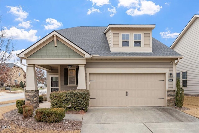 craftsman house with roof with shingles and driveway