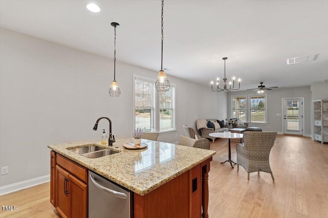 kitchen featuring a sink, visible vents, light wood-style floors, open floor plan, and stainless steel dishwasher