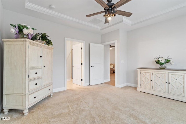 unfurnished bedroom featuring light carpet, a tray ceiling, and crown molding