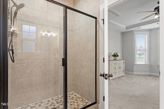 bathroom featuring a stall shower, baseboards, a raised ceiling, and a ceiling fan