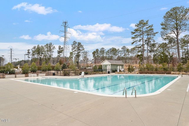 pool featuring a patio area and fence