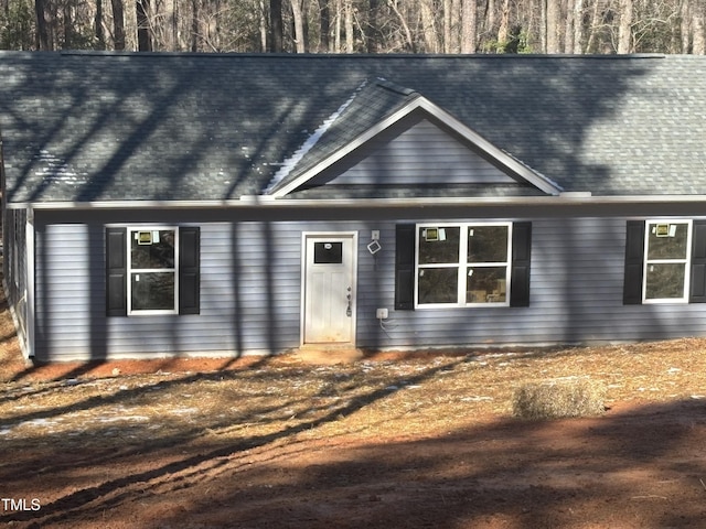 view of front of property featuring roof with shingles