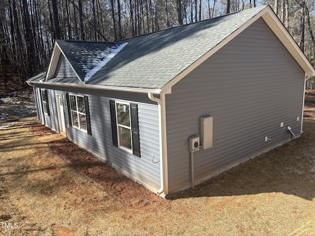 view of property exterior featuring roof with shingles