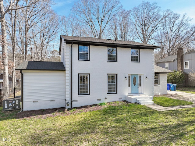 view of front of house with crawl space, roof with shingles, a front lawn, and brick siding