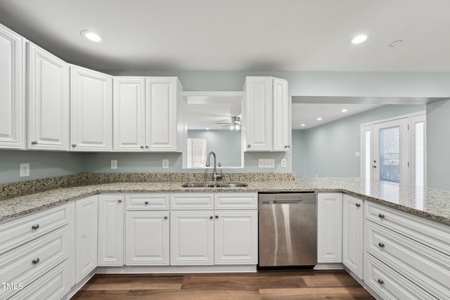 kitchen featuring recessed lighting, a sink, white cabinetry, stainless steel dishwasher, and dark wood-style floors