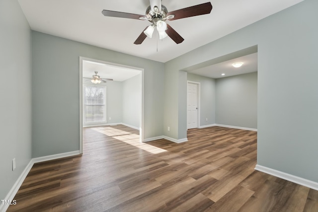 unfurnished room with baseboards and wood finished floors