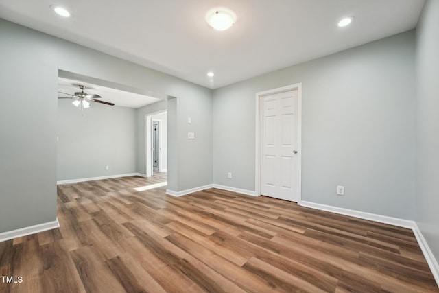 unfurnished room featuring recessed lighting, baseboards, and wood finished floors