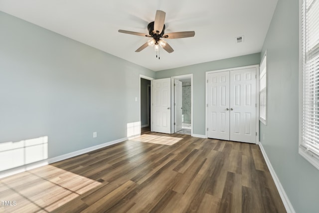 unfurnished bedroom featuring a closet, ceiling fan, baseboards, and wood finished floors