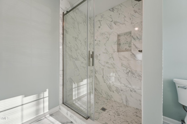 bathroom featuring marble finish floor, baseboards, toilet, and a marble finish shower