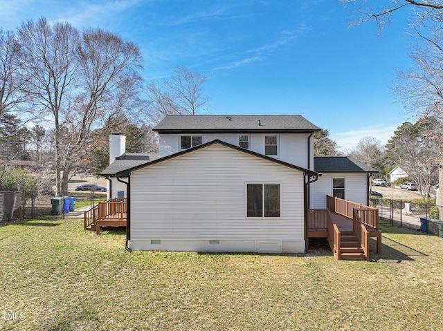 back of house featuring a yard, a chimney, crawl space, a deck, and a fenced backyard