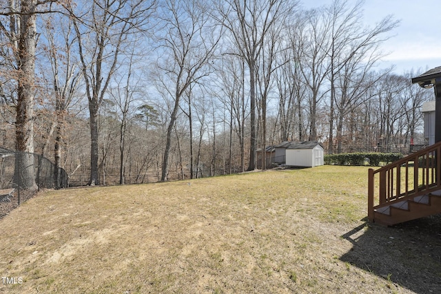 view of yard with an outbuilding and a shed