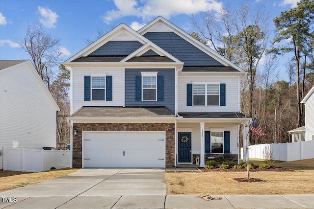 craftsman house featuring a garage, fence, a porch, and concrete driveway