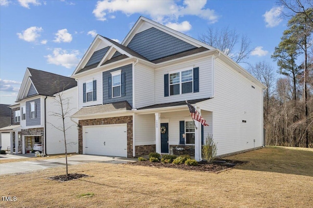 craftsman inspired home with a porch, concrete driveway, a front yard, a garage, and stone siding