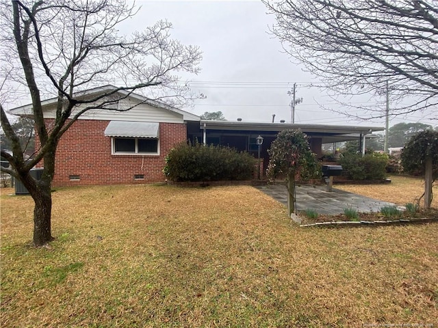 rear view of house with a yard and a carport