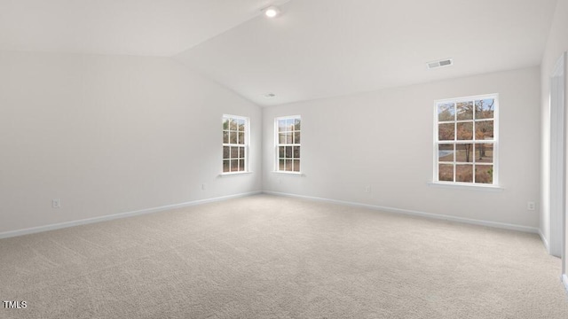 139 Ethel Ln, Angier, NC 27501 - spare room featuring light carpet, baseboards, and vaulted ceiling