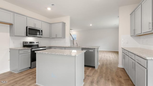 139 Ethel Ln, Angier, NC 27501 - kitchen with appliances with stainless steel finishes, a peninsula, a sink, gray cabinets, and recessed lighting