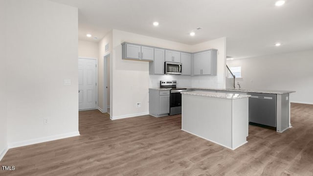 139 Ethel Ln, Angier, NC 27501 - kitchen with appliances with stainless steel finishes, gray cabinets, a center island, a peninsula, and recessed lighting