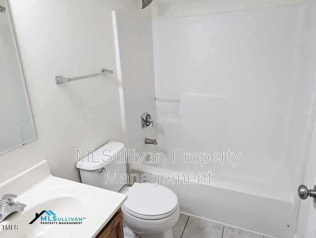 bathroom featuring washtub / shower combination, vanity, and toilet