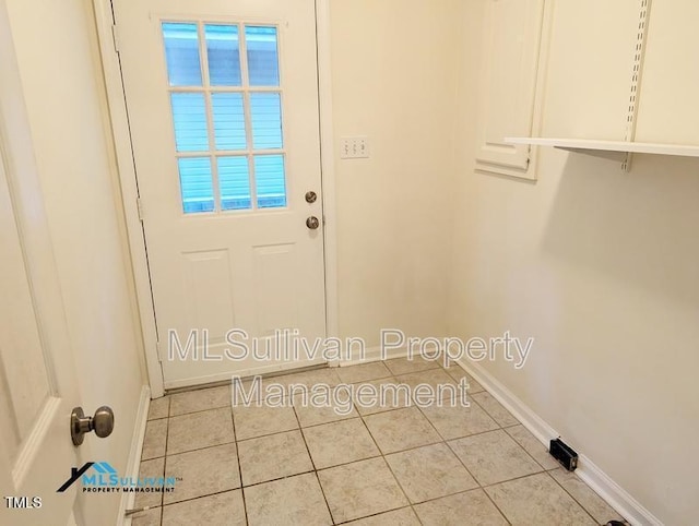 entryway featuring tile patterned flooring and baseboards