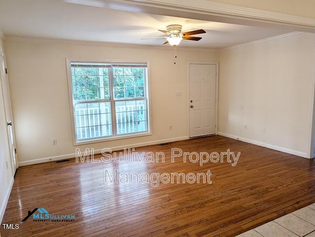 unfurnished room with ornamental molding, visible vents, and wood finished floors