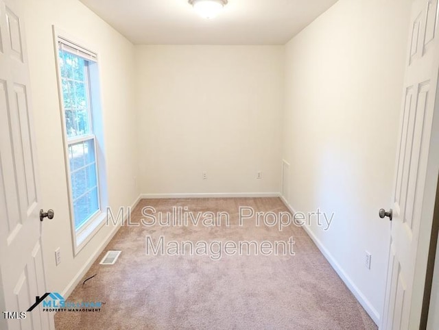 unfurnished room with baseboards, visible vents, and carpet flooring