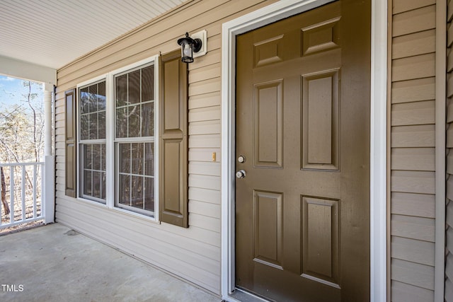 view of exterior entry featuring a porch