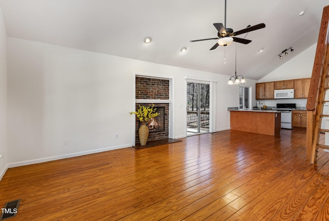 unfurnished living room featuring a fireplace, baseboards, dark wood finished floors, and ceiling fan with notable chandelier