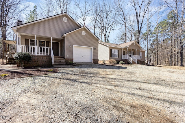 single story home with driveway, covered porch, and a garage