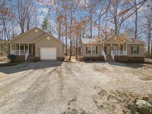 view of front facade with driveway, a porch, crawl space, and an attached garage