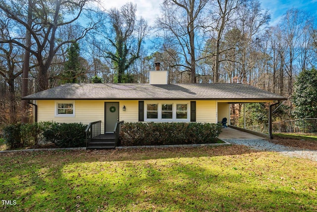 ranch-style home with a front yard and a carport